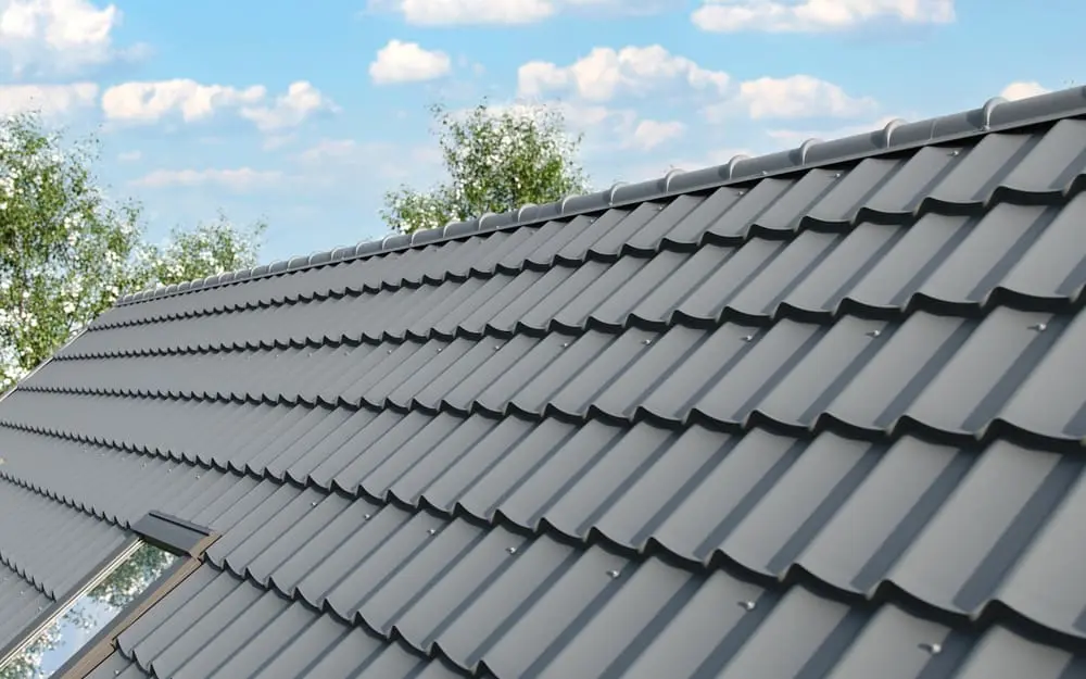 Close-up of a house roof with traditional metal steel roofing shingles