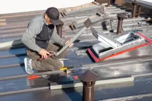 New roof with skylight windows in a mansard attic