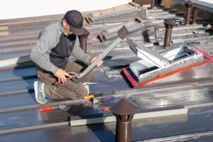 New roof with skylight windows in a mansard attic